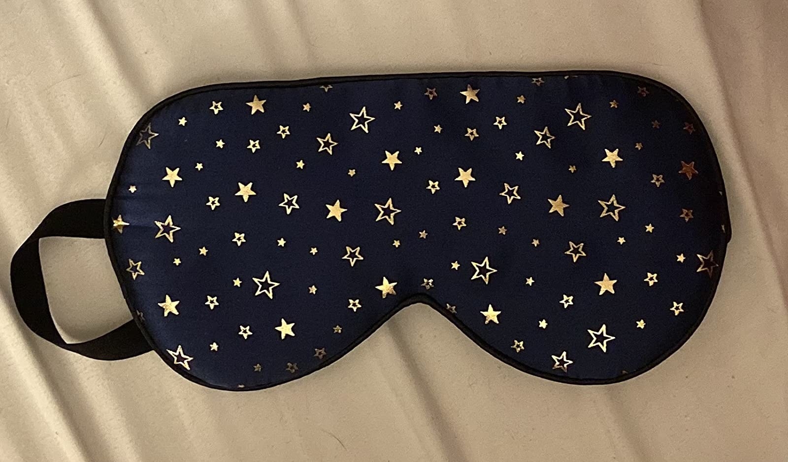 the blue face mask with golden stars on it