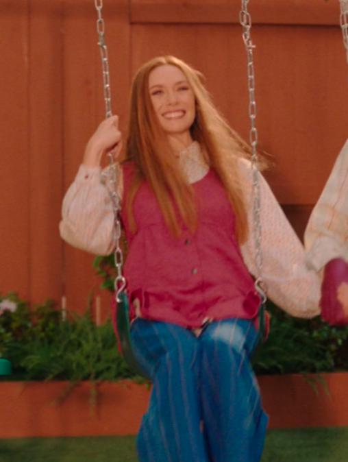 bell bottoms and a vest over a blouse