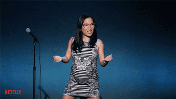 A gif of pregnant Ali Wong on stage