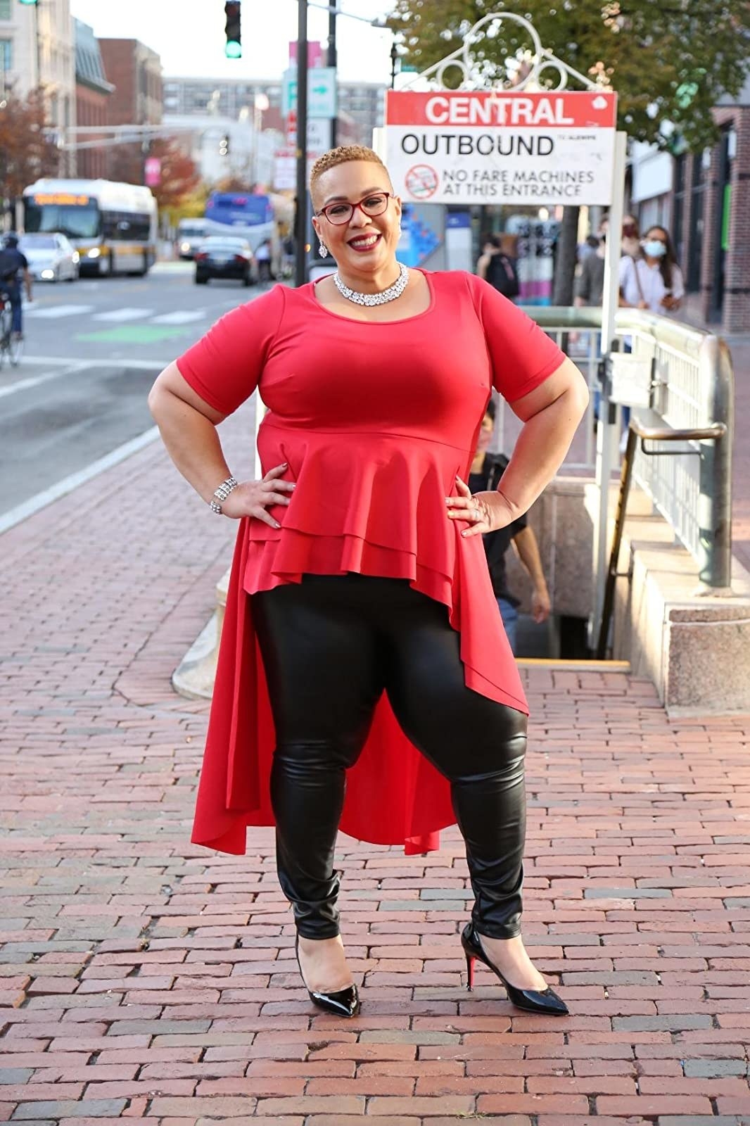 Reviewer is wearing a red high low top and black leather leggings