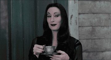 Morticia Addams going to take a sip of her tea