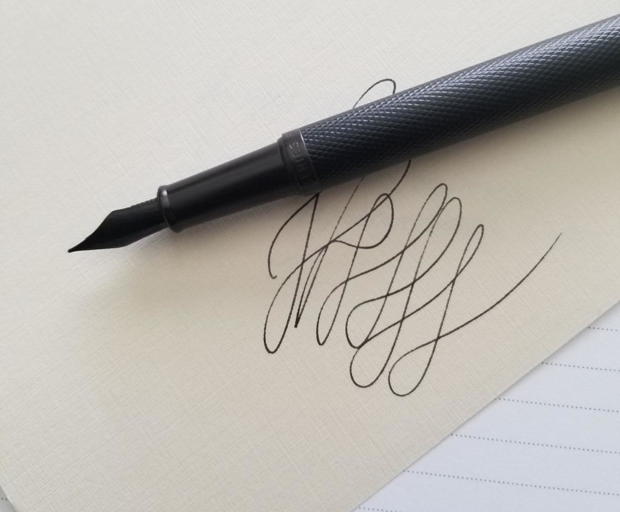 the pen with calligraphy lines underneath it