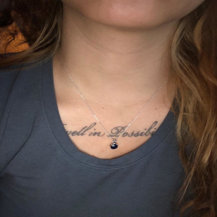 reviewer wearing the blue sapphire necklace