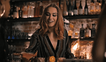 tess winking as she serves a drink