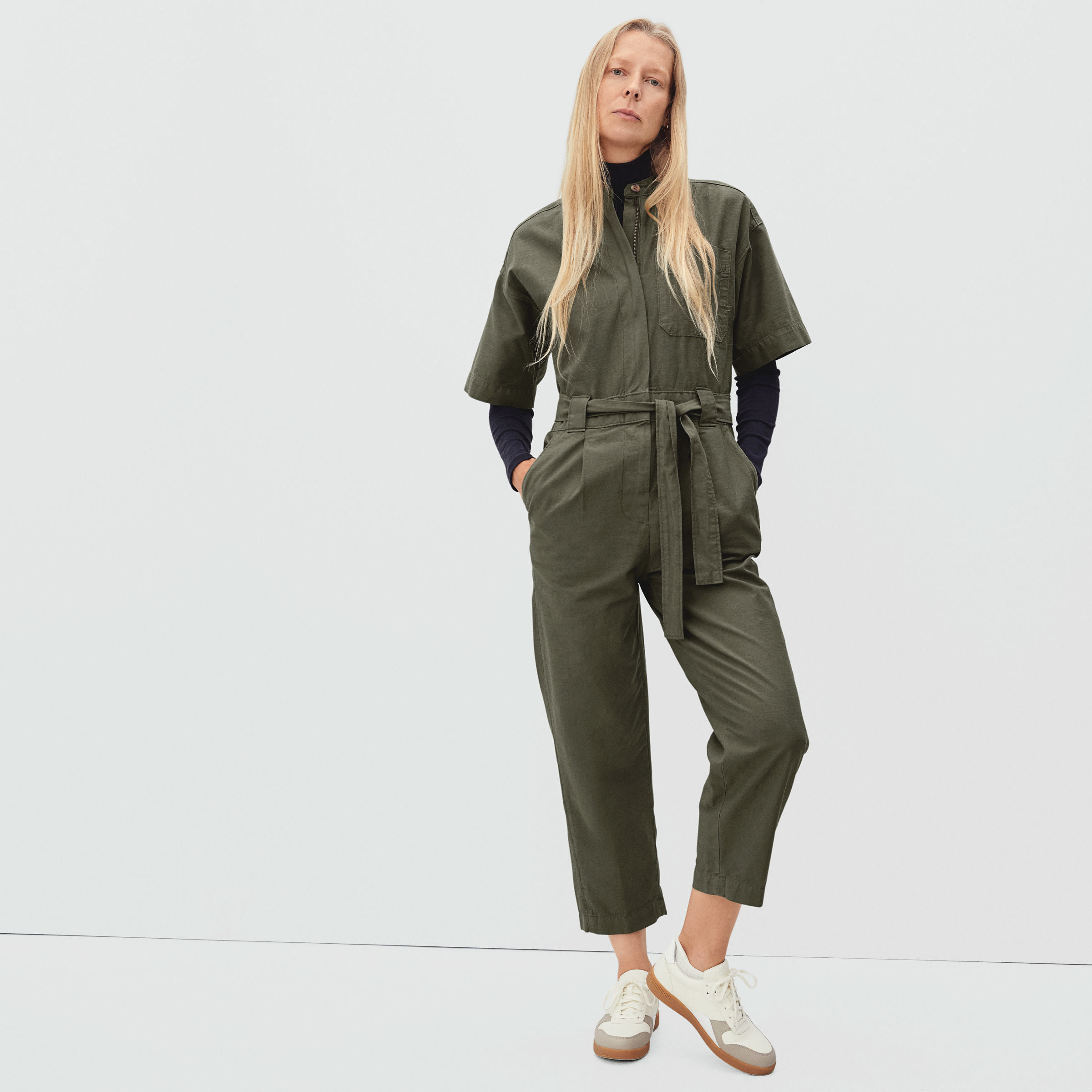 model wearing the green ankle-length short-sleeved jumpsuit