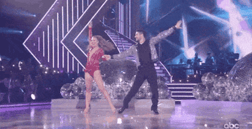 A gif of two people dancing, one of them is making the other twirl