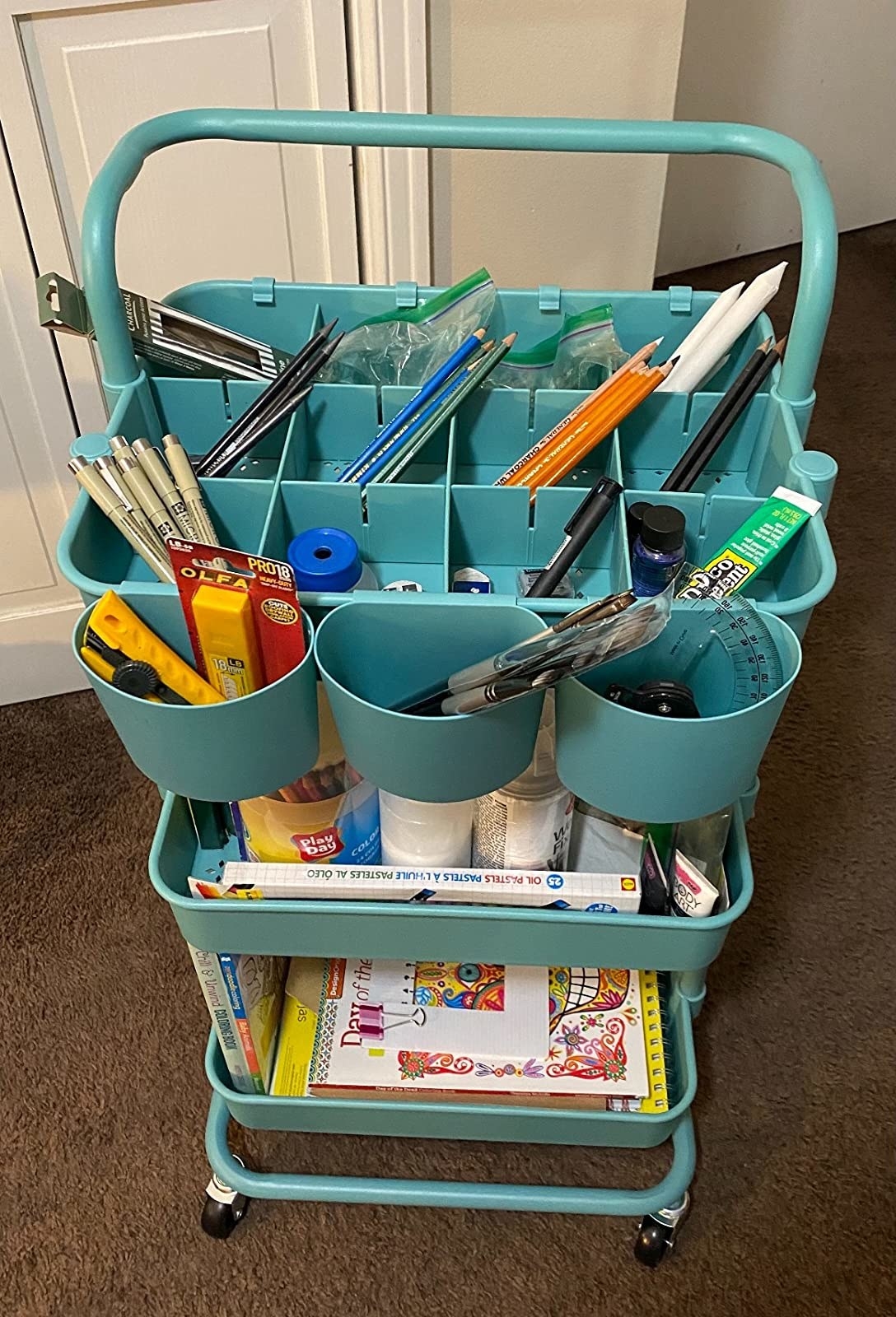 reviewer&#x27;s blue utility cart with art supplies in it