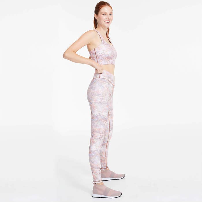A person wearing a pair of leggings and sports bra