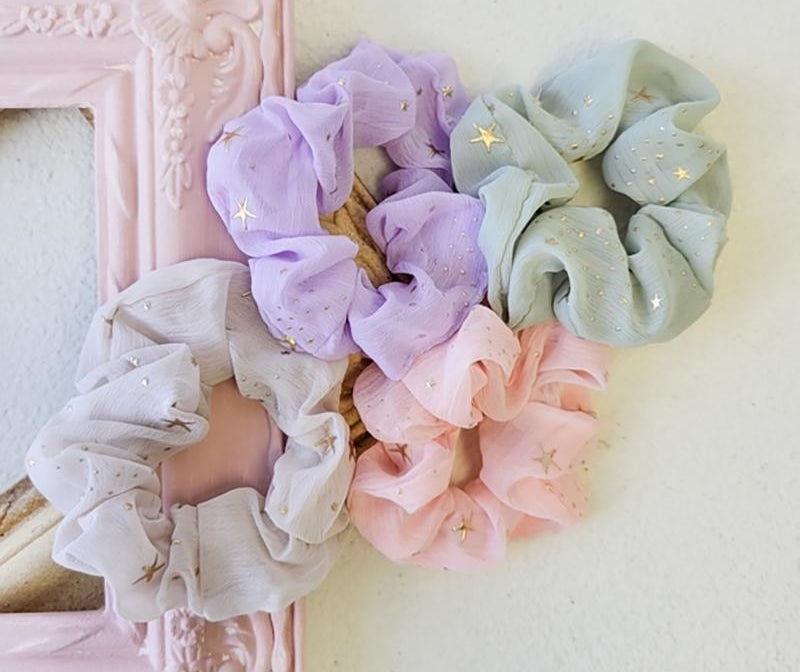 Four scrunchies in different colours in a group