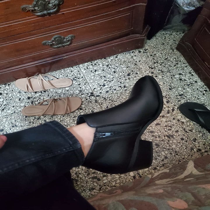black heeled boot with a zipper on the side