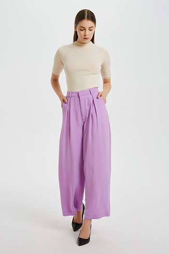 a model wearing the palazzo pants in a violet color