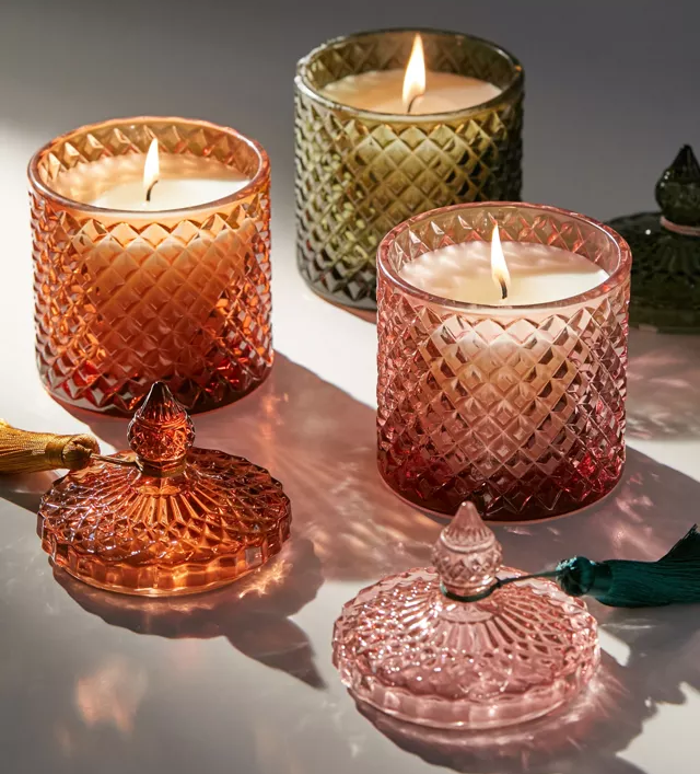 Three candles in glass jars with lids