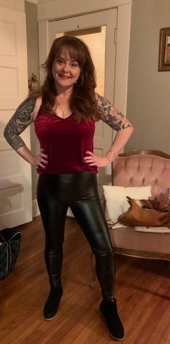reviewer in red velvet tank and faux leather leggings