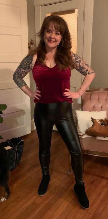 reviewer in red velvet tank and faux leather leggings
