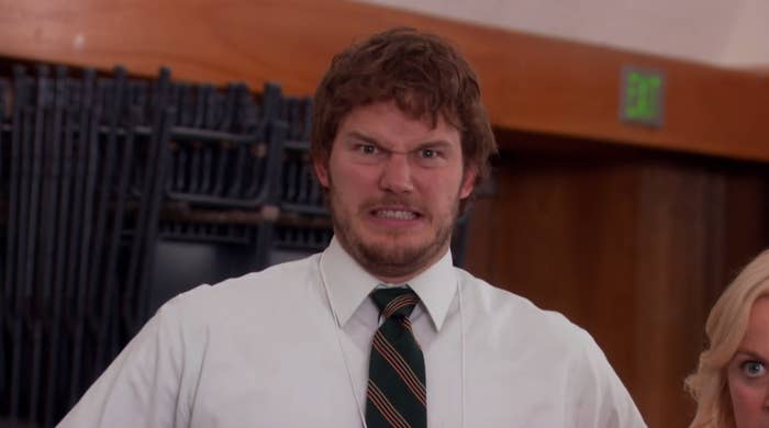Andy making a grimacing face at the camera on Parks and Rec