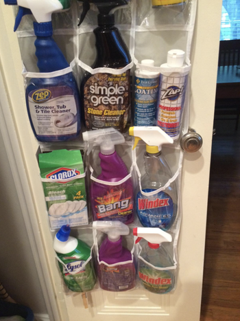 reviewer pic of cleaning supplies in the organizer's pockets
