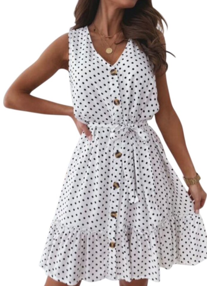 A sleeveless, white button-up dress with black polka dots