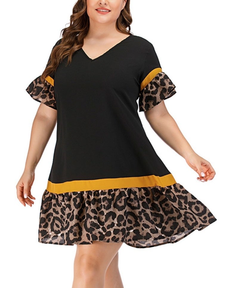 A model wearing a black/yellow/leopard printed v-necked, short-sleeve swing dress