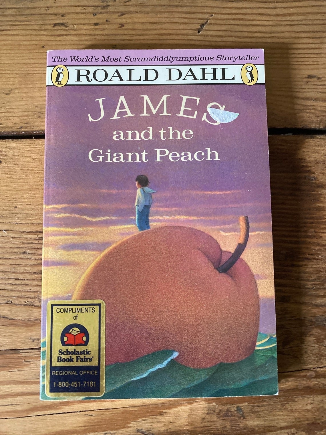 Cover with James standing on a giant peach staring into the sunset