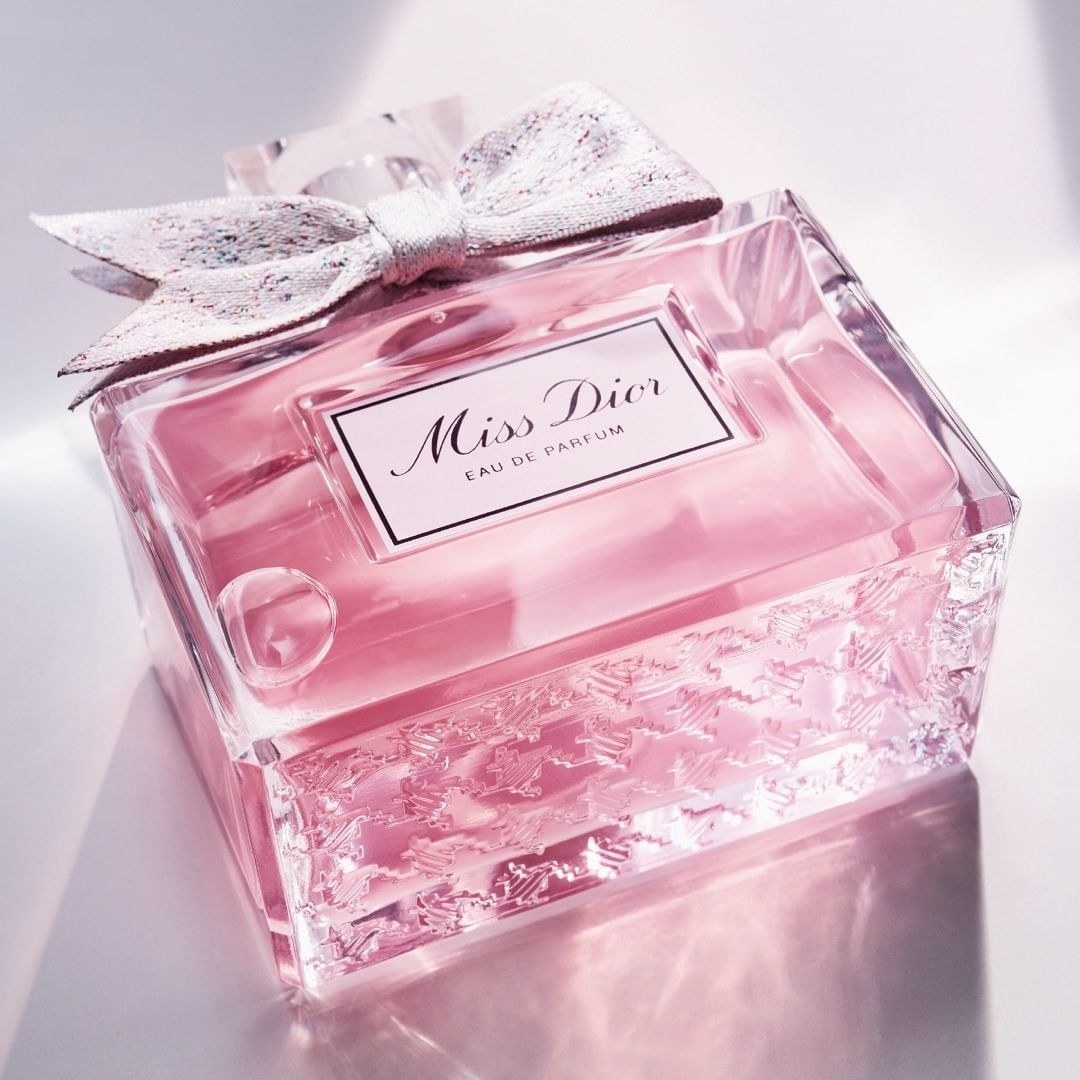 a bottle of perfume with a bow at the top