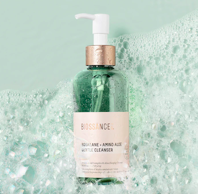 A bottle of face cleanser covered in bubbles