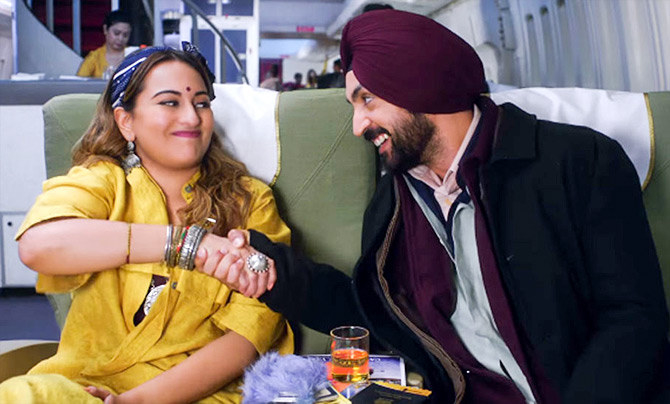 Sonakshi Sinha and Diljit Dosanjh shaking hands with a smile on their faces