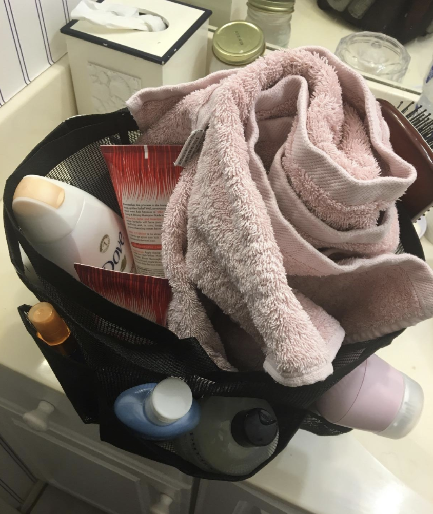 A reviewer&#x27;s caddy with a variety of products, tools, and a towel