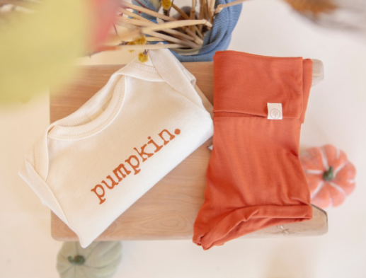A photo of baby clothing that says &quot;pumpkin&quot;