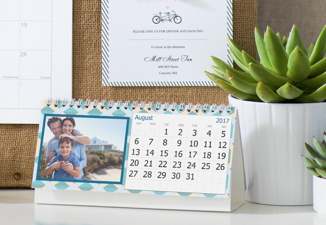 A custom calendar with a family photo printed next to the dates on a desk