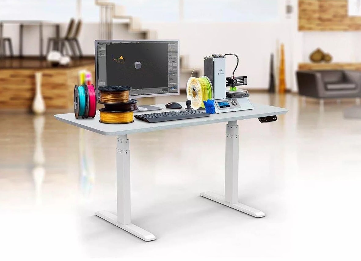 The white height-adjustable desk frame
