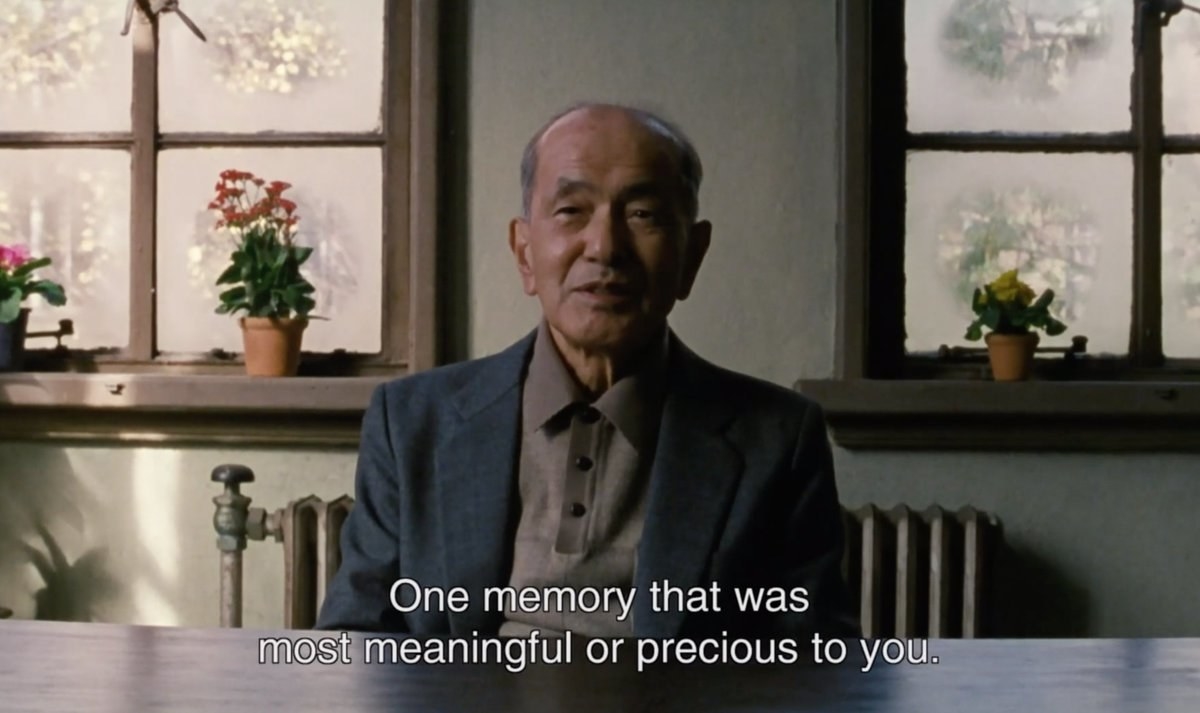 a man sits at a table and says &quot;one memory that was most meaningful or precious to you&quot;