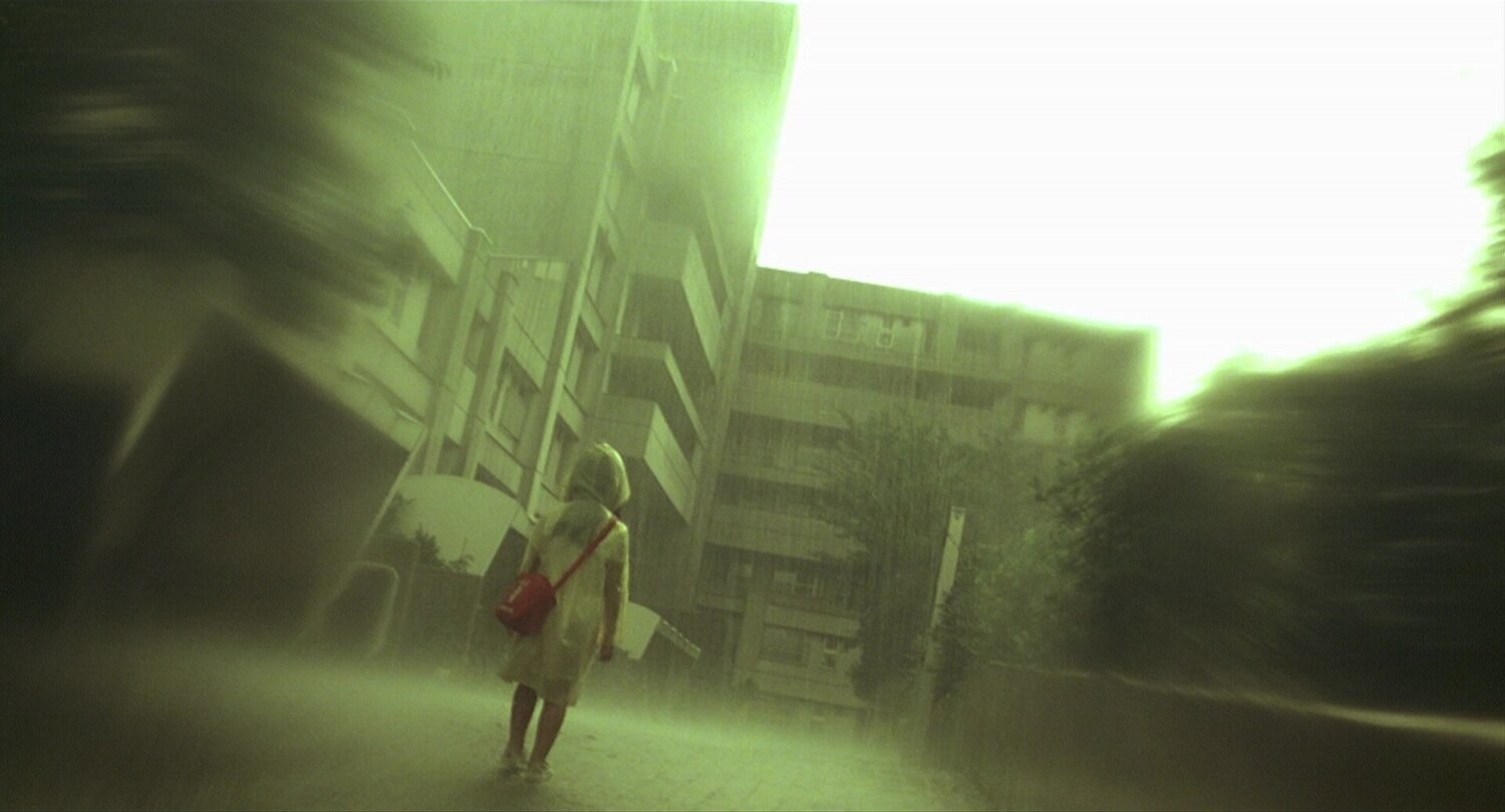 young girl walks through the streets, tall buildings around her