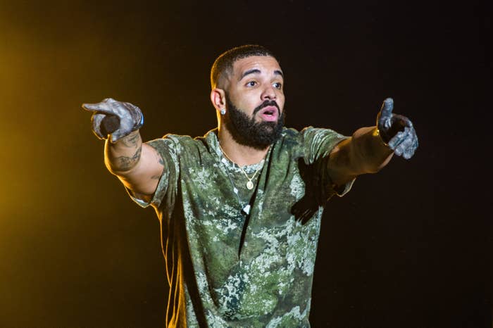 Drake pointing with both hands onstage