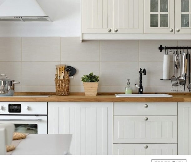 Knobs shown on white kitchen cabinets.