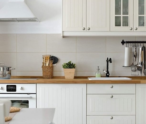 Knobs shown on white kitchen cabinets.
