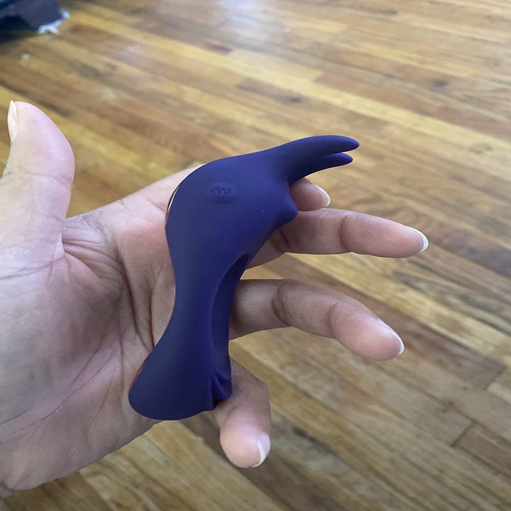 A reviewer holding the ring sideways to show off the probes