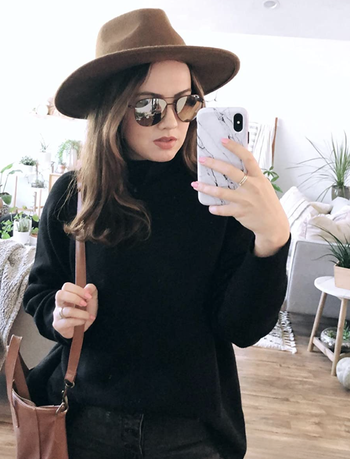 reviewer wearing the black sweater