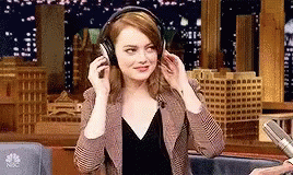 Emma Stone dancing with headphones on