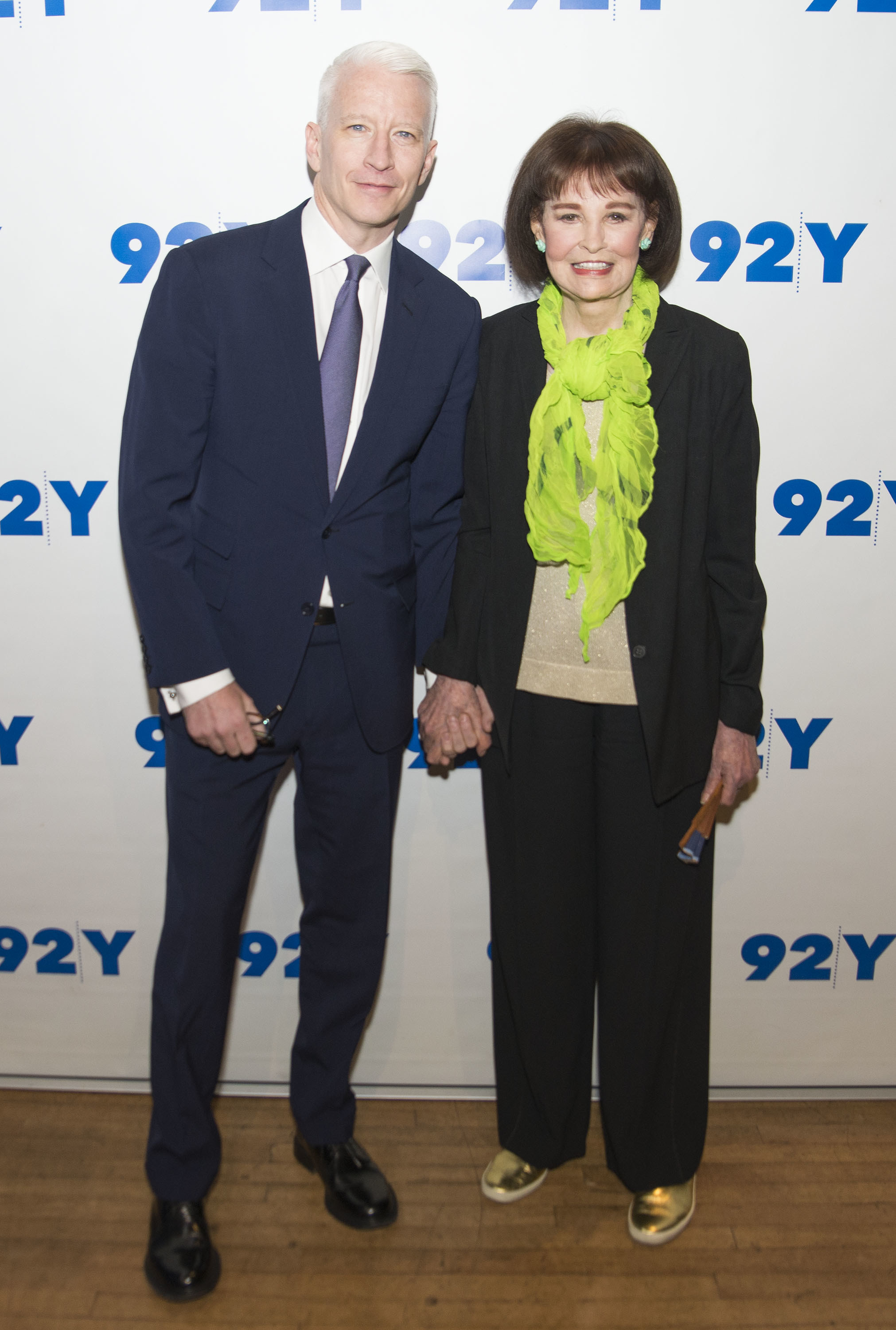 Anderson Cooper and Gloria Vanderbilt holding hands on the red carpet