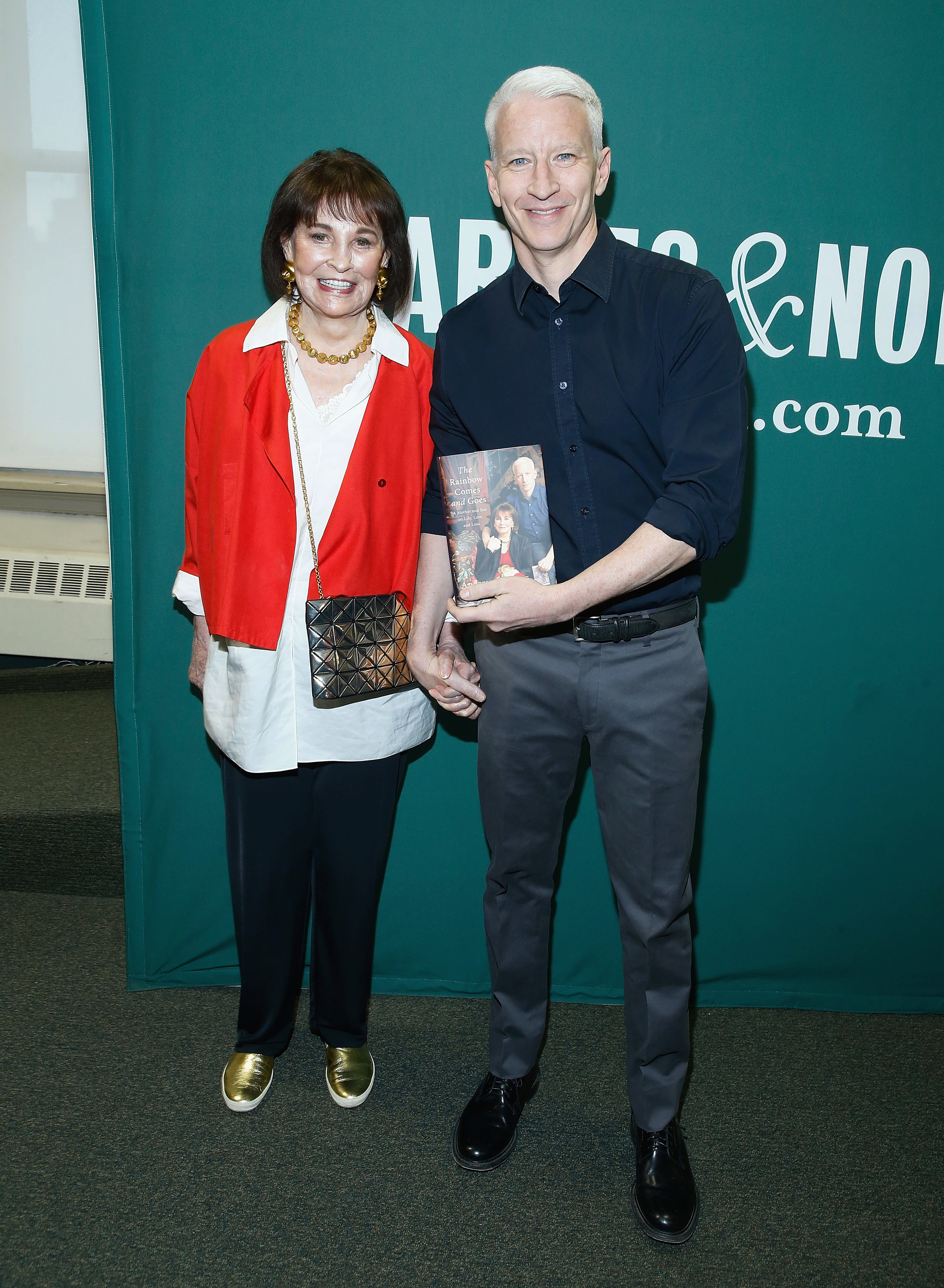 Anderson Cooper and Gloria Vanderbilt smiling and holding hands