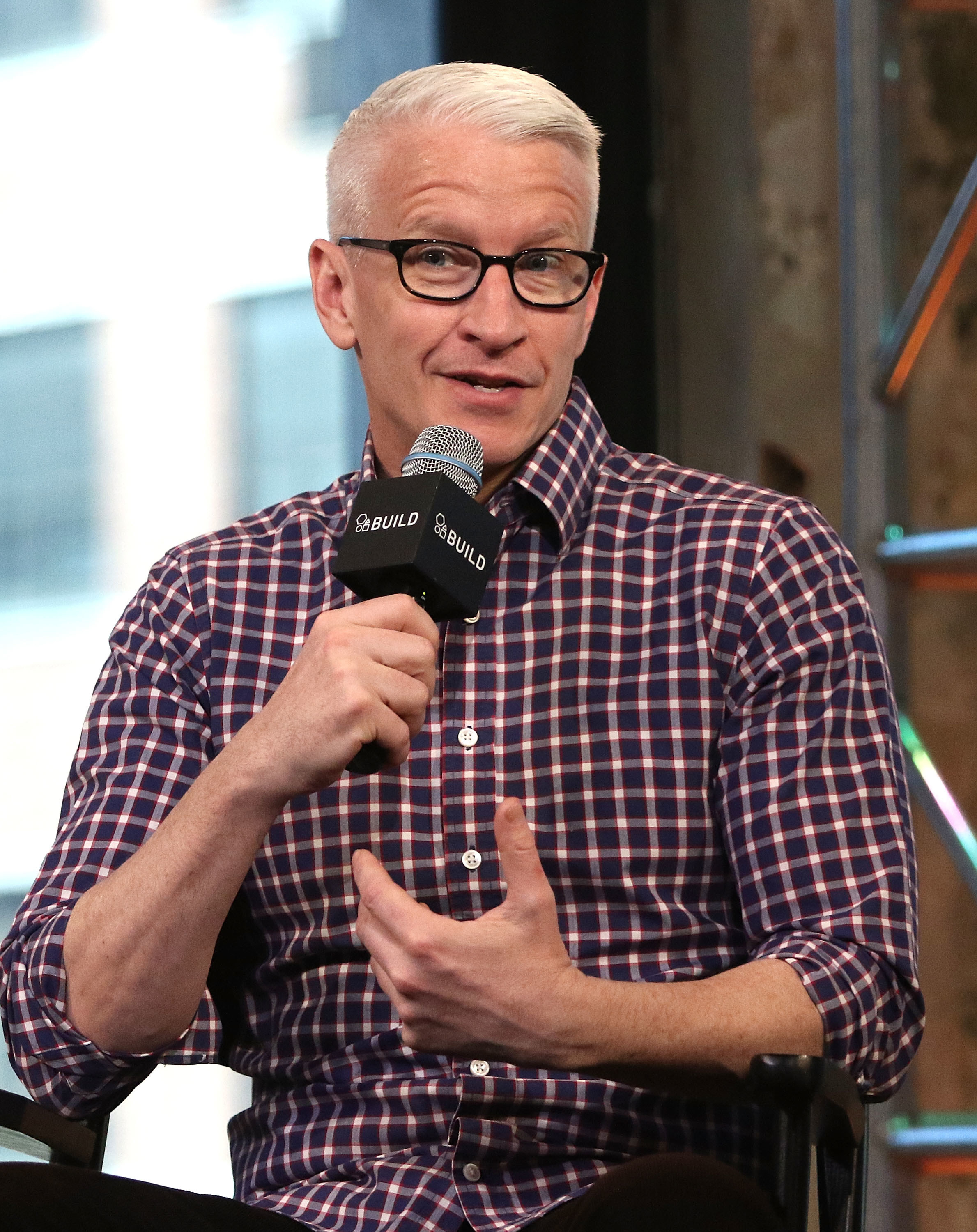Anderson Cooper speaking into a microphone