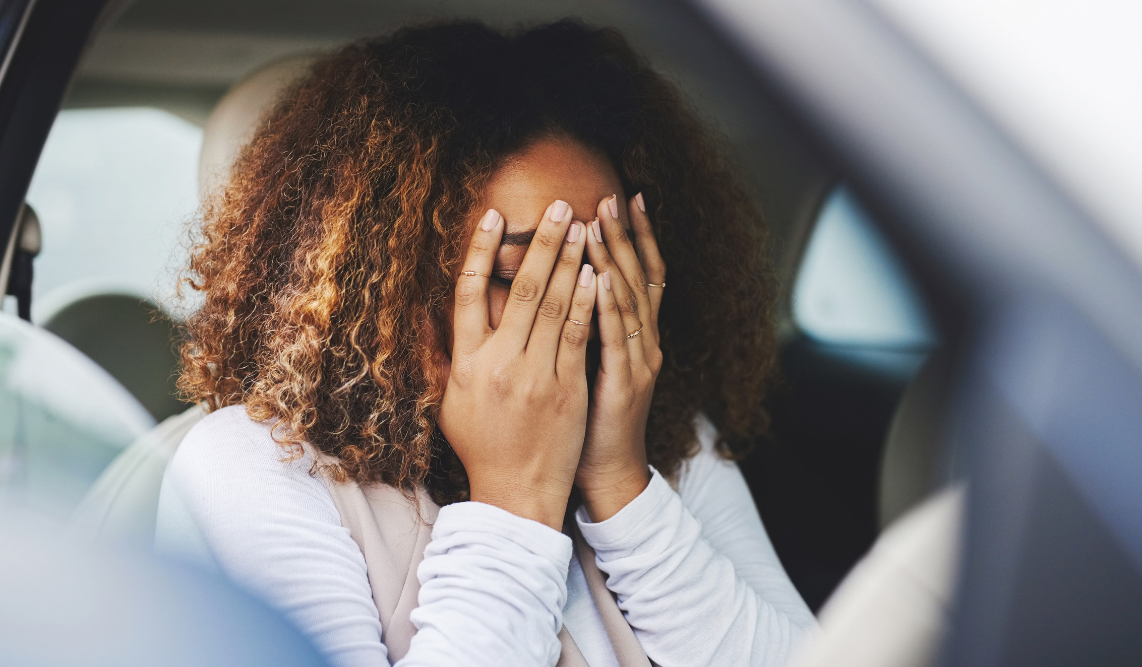 upset woman in her car