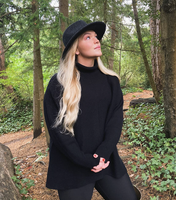 reviewer wearing the black sweater