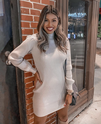 reviewer wearing the white dress 