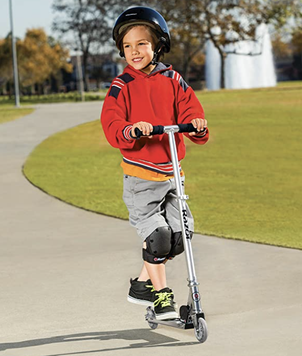 boy on silver Razor scooter