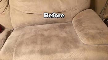 a reviewer's tan couch with a dark stain on the seat and text reading 