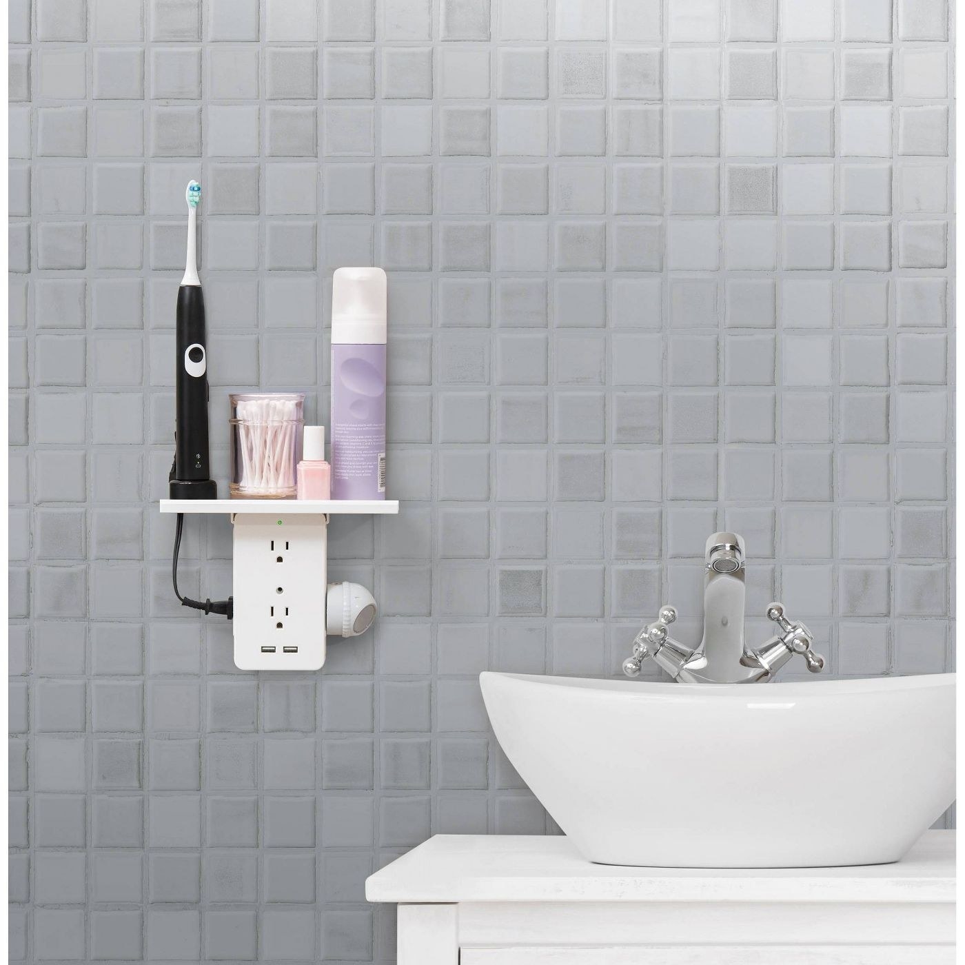 the outlet shelf with an electric toothbrush and toiletries stored on the shelf