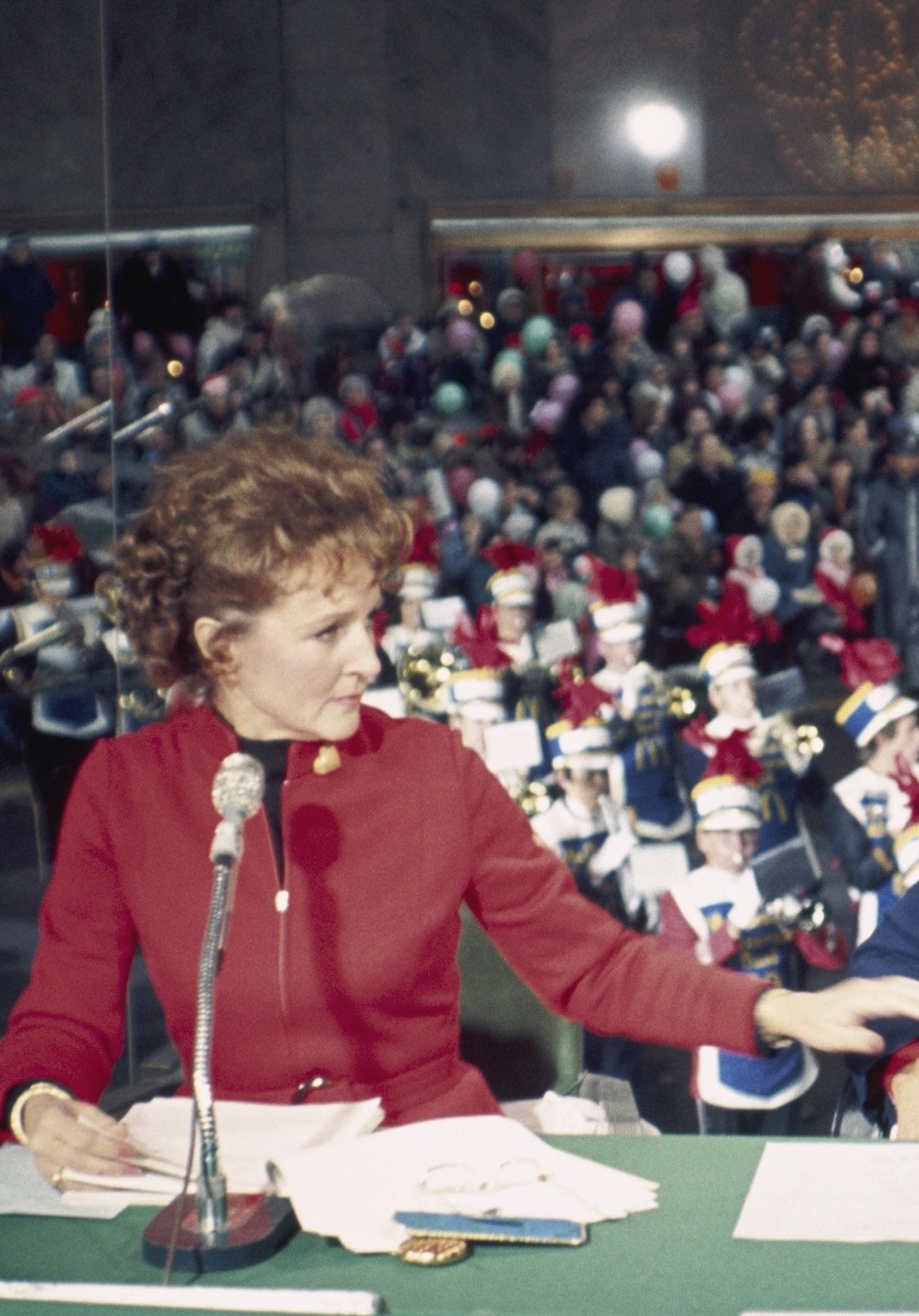 Betty is narrating the parade for the TV audience