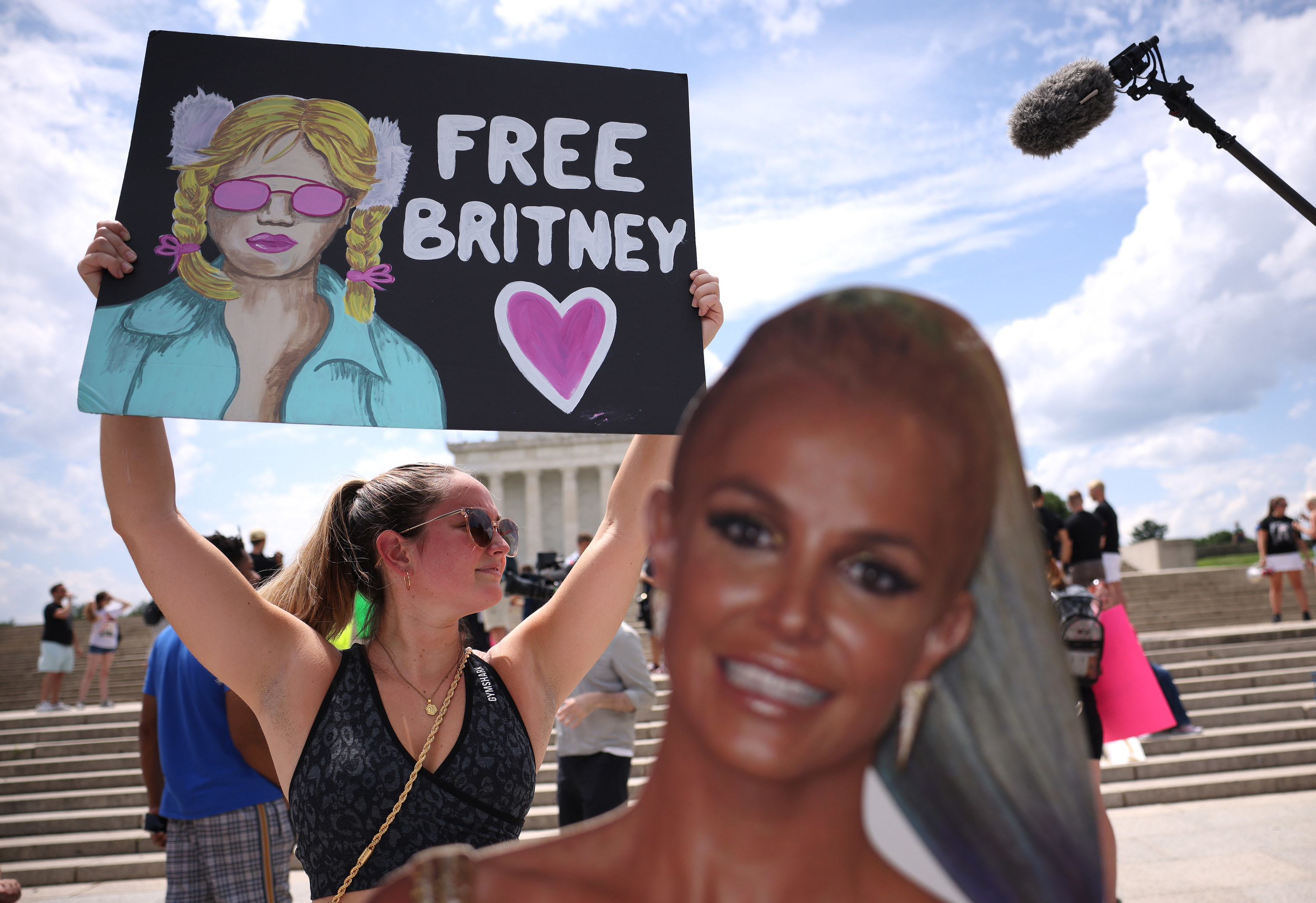Photo of a person holding a Free Britney sign at a rally