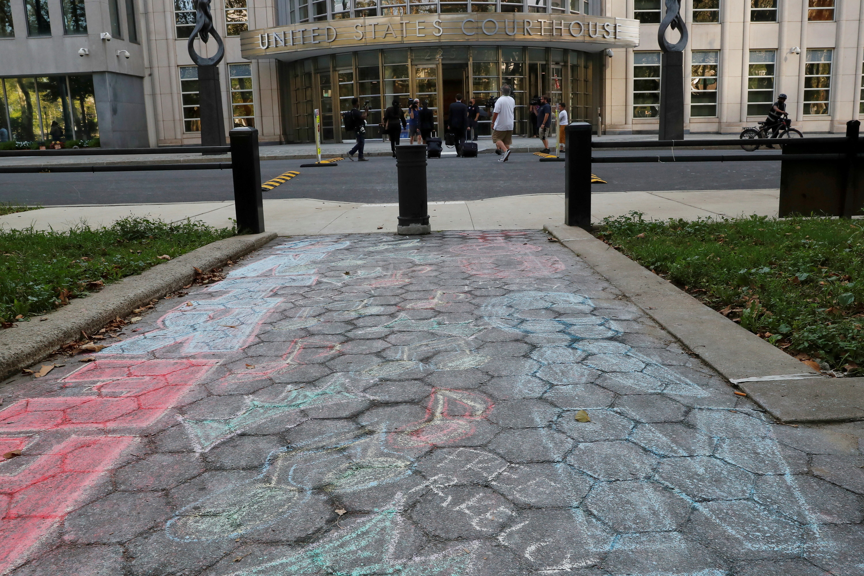 &quot;Free R Kelly&quot; is written in chalk on a sidewalk